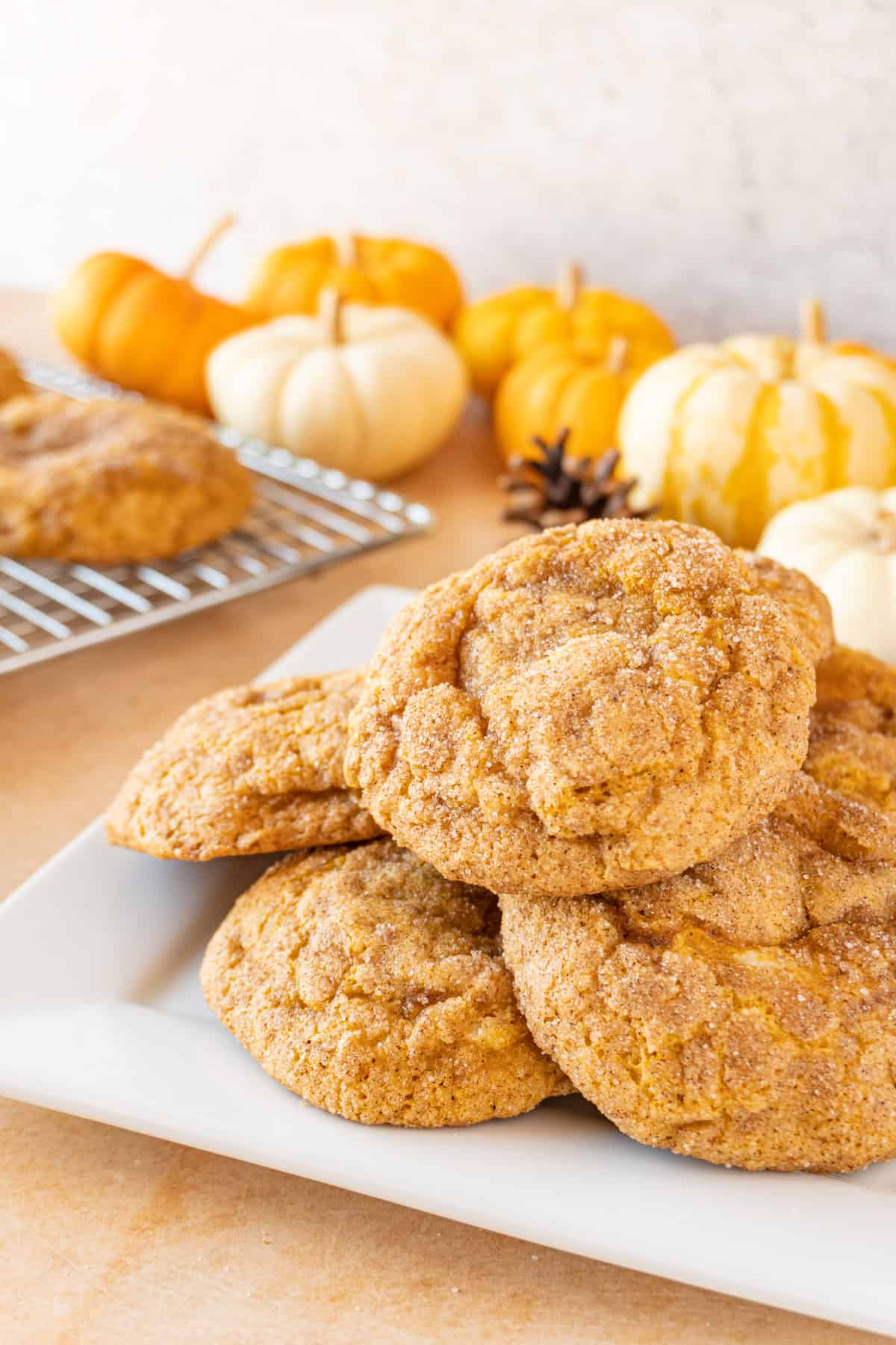 pumpkin cheesecake cookies on plate piled up