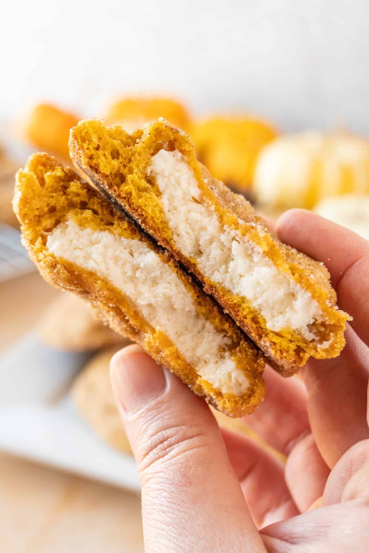 pumpkin cheesecake cookie broken open to show filling