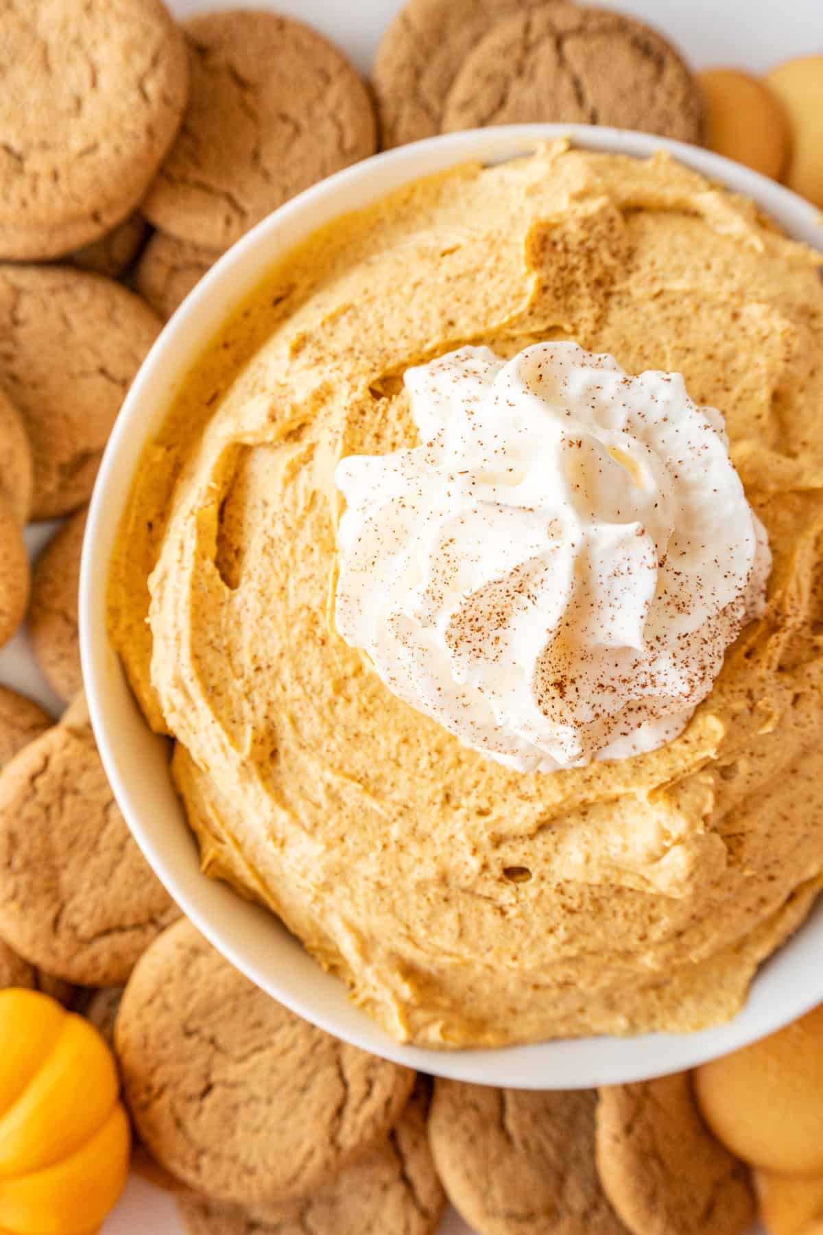 pumpkin fluff in bowl surrounded by cookies