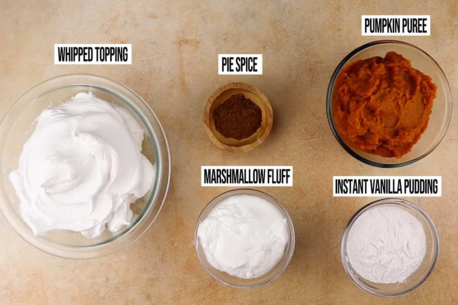 Pumpkin Fluff Dip Ingredients in individual bowls and labeled.