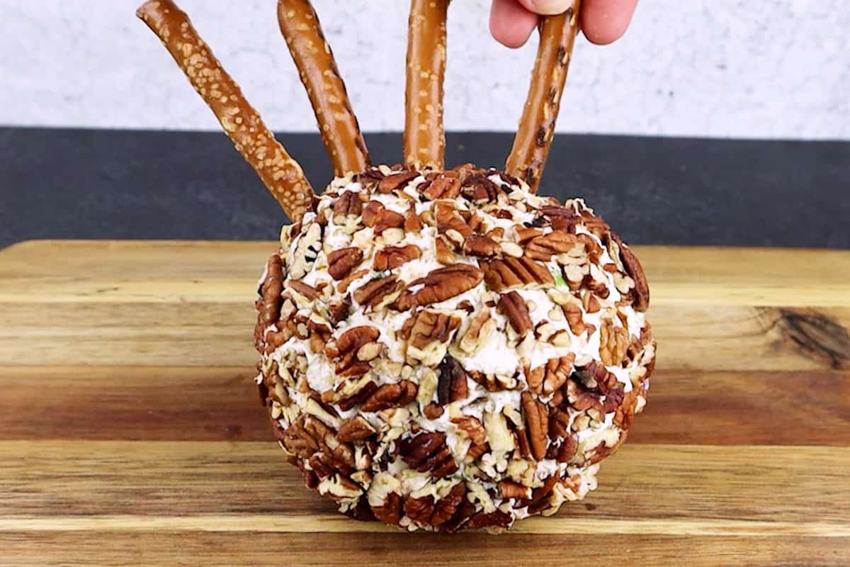 adding pretzels to cheese ball