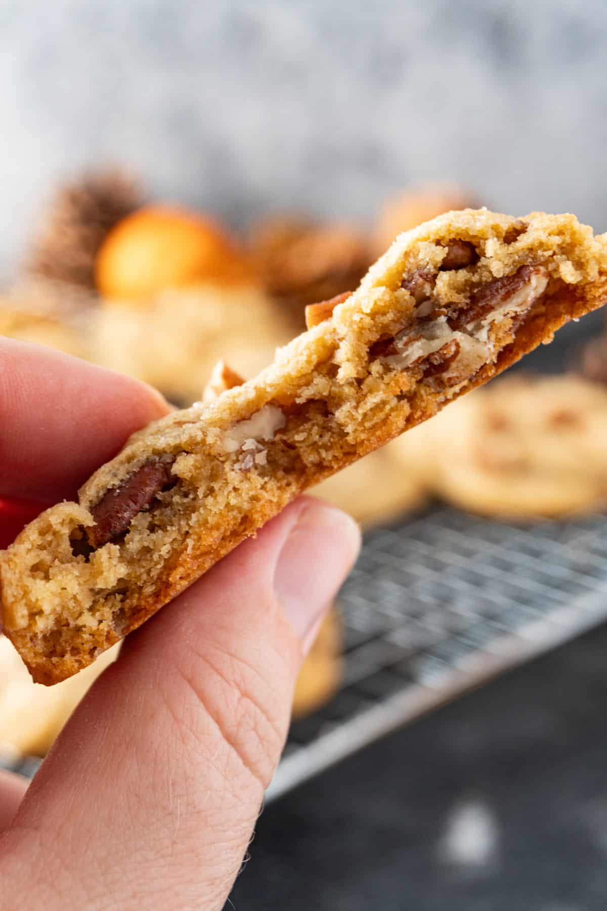 holding half a pecan pie cookie