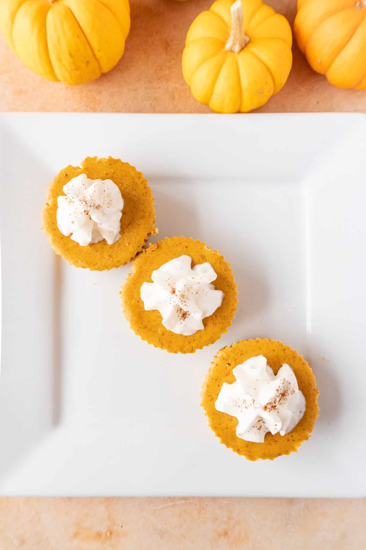 Mini Pumpkin Cheesecakes on plate flat lay