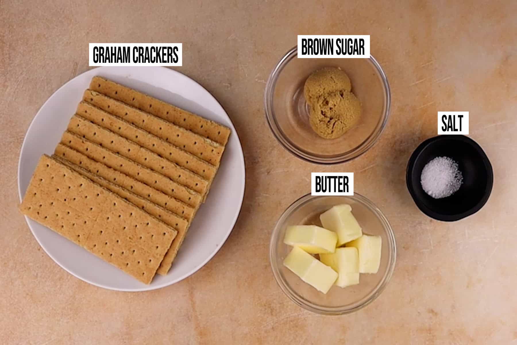 Mini Pumpkin Cheesecake crust Ingredients in individual bowls and labeled.
