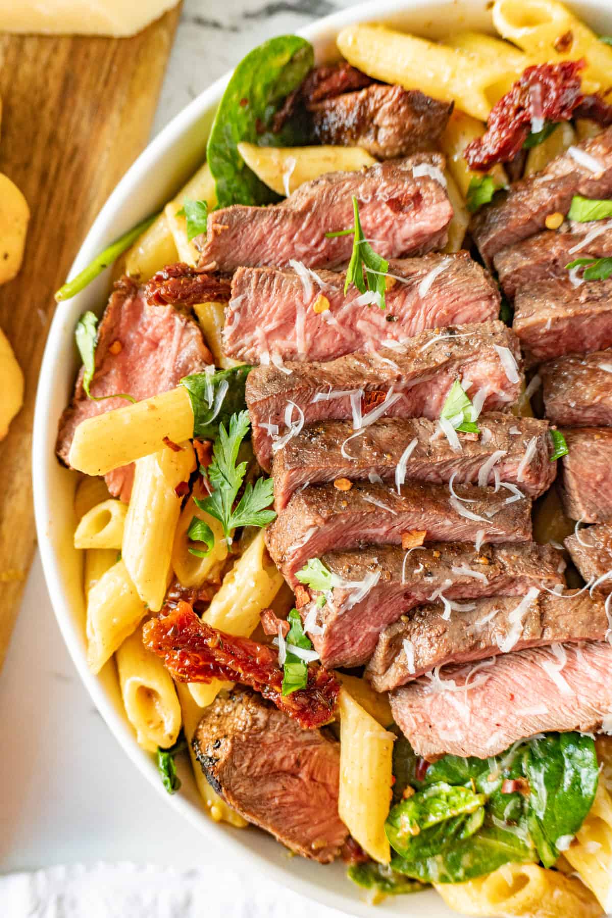 close up of steak pasta in bowl