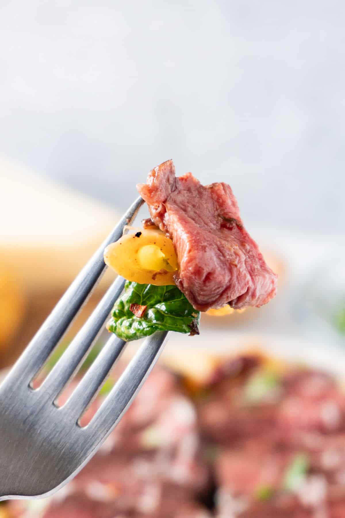 steak and paste on fork