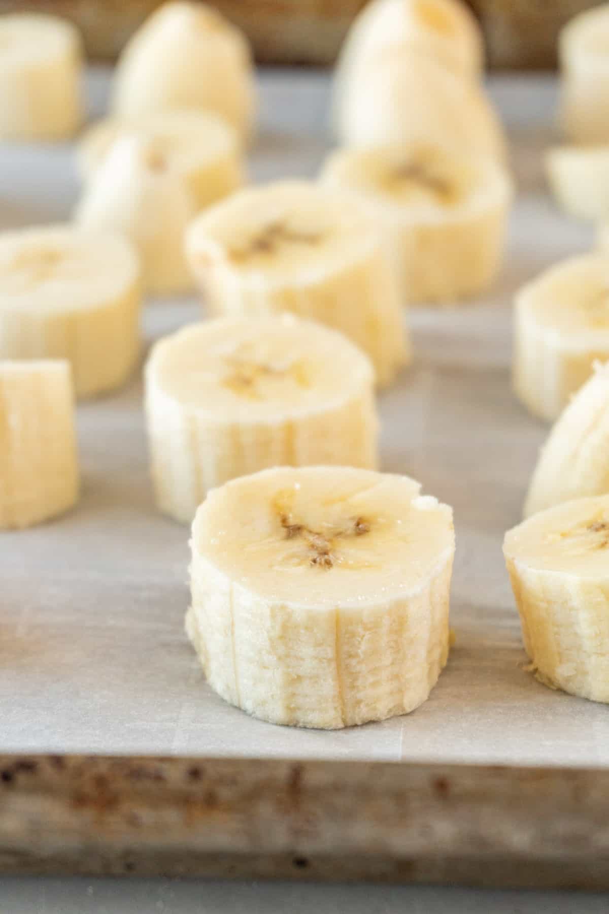 sliced bananas on baking sheet