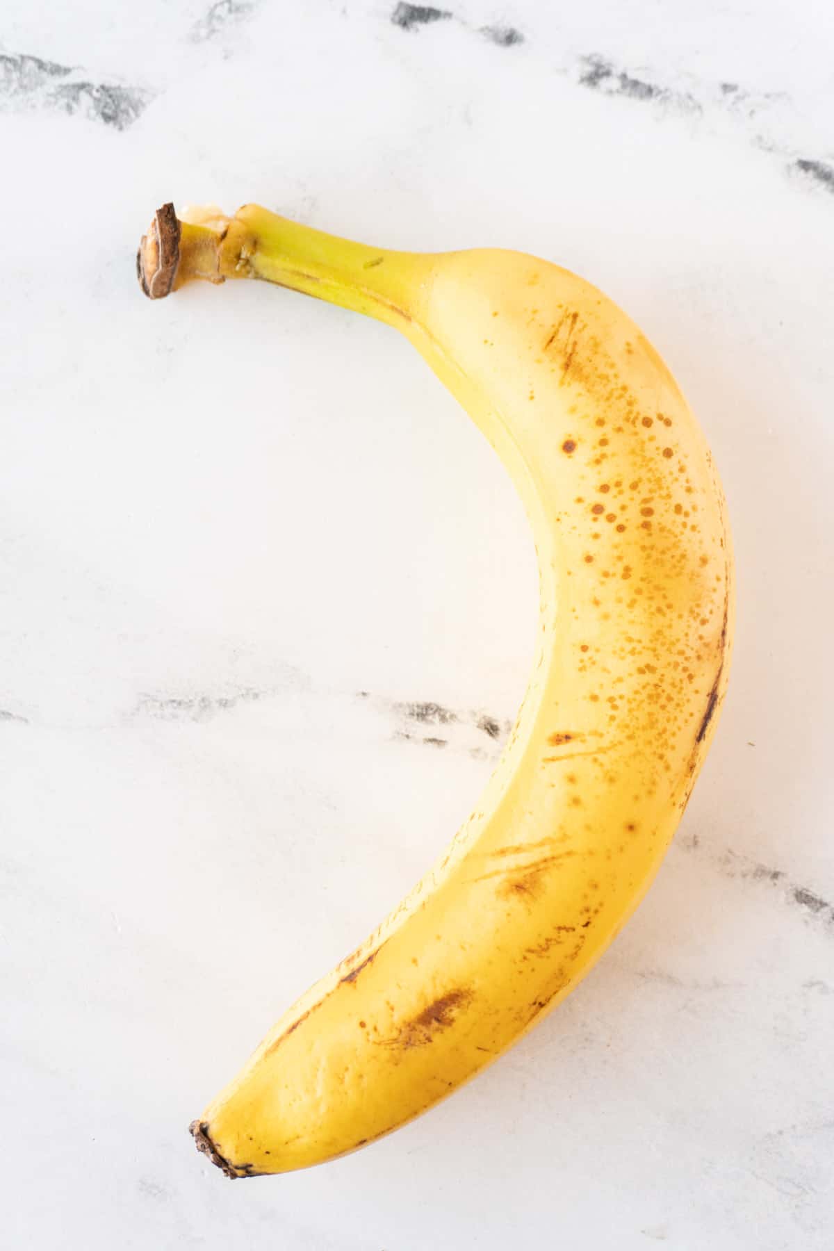 yellow whole banana with peel on