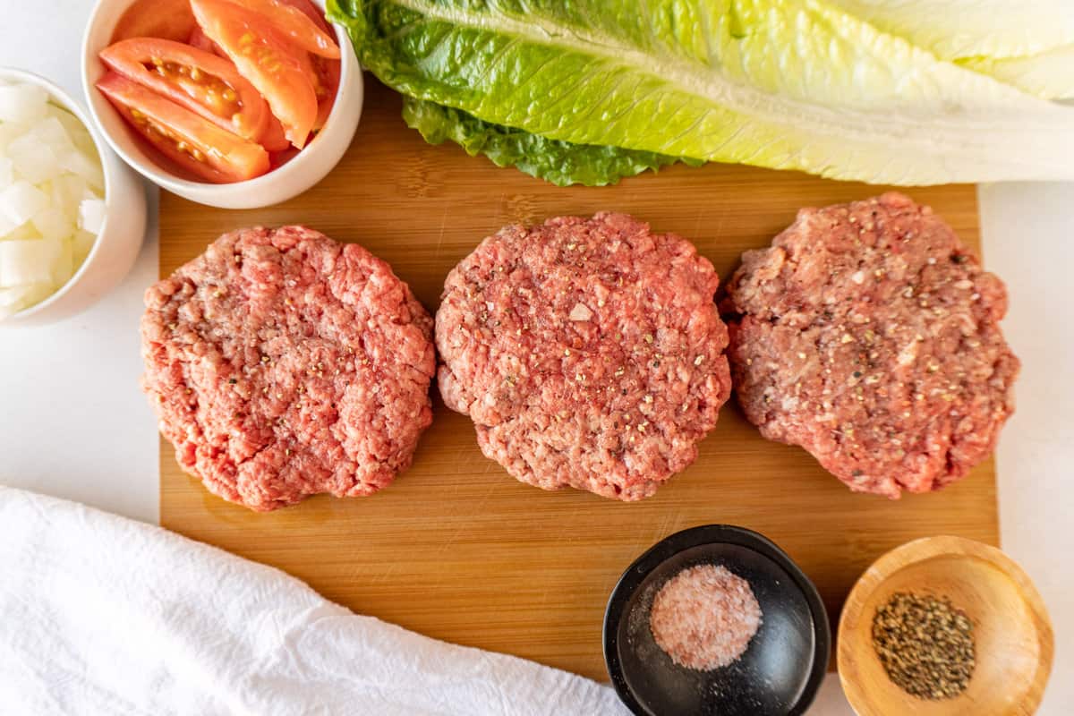 wagyu burger patties with  burger ingredients around them