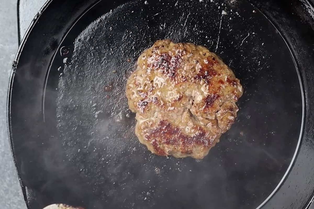 burger being cooked in pan