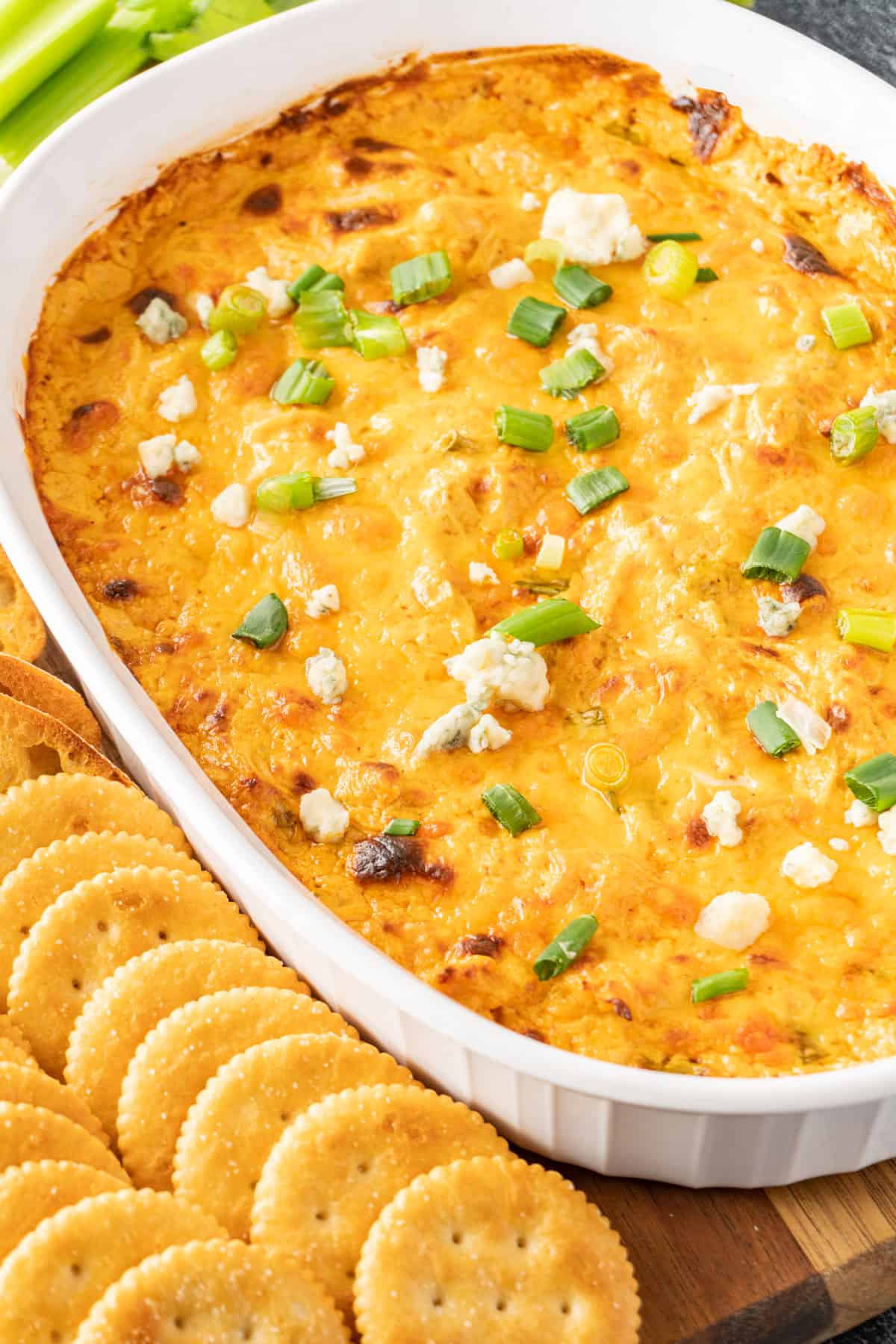 franks red hot buffalo chicken dip in dish with crackers next to it