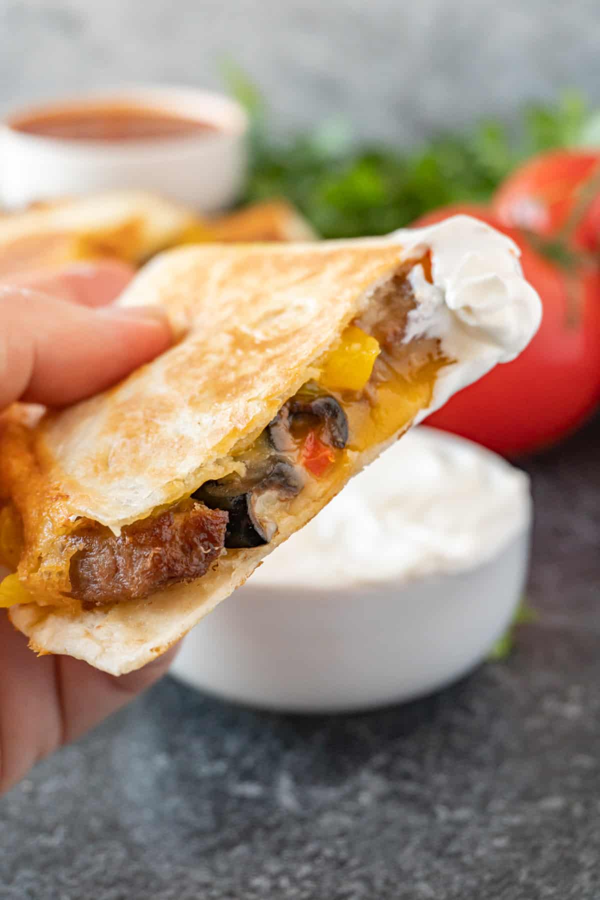 steak quesadilla with sour cream on it