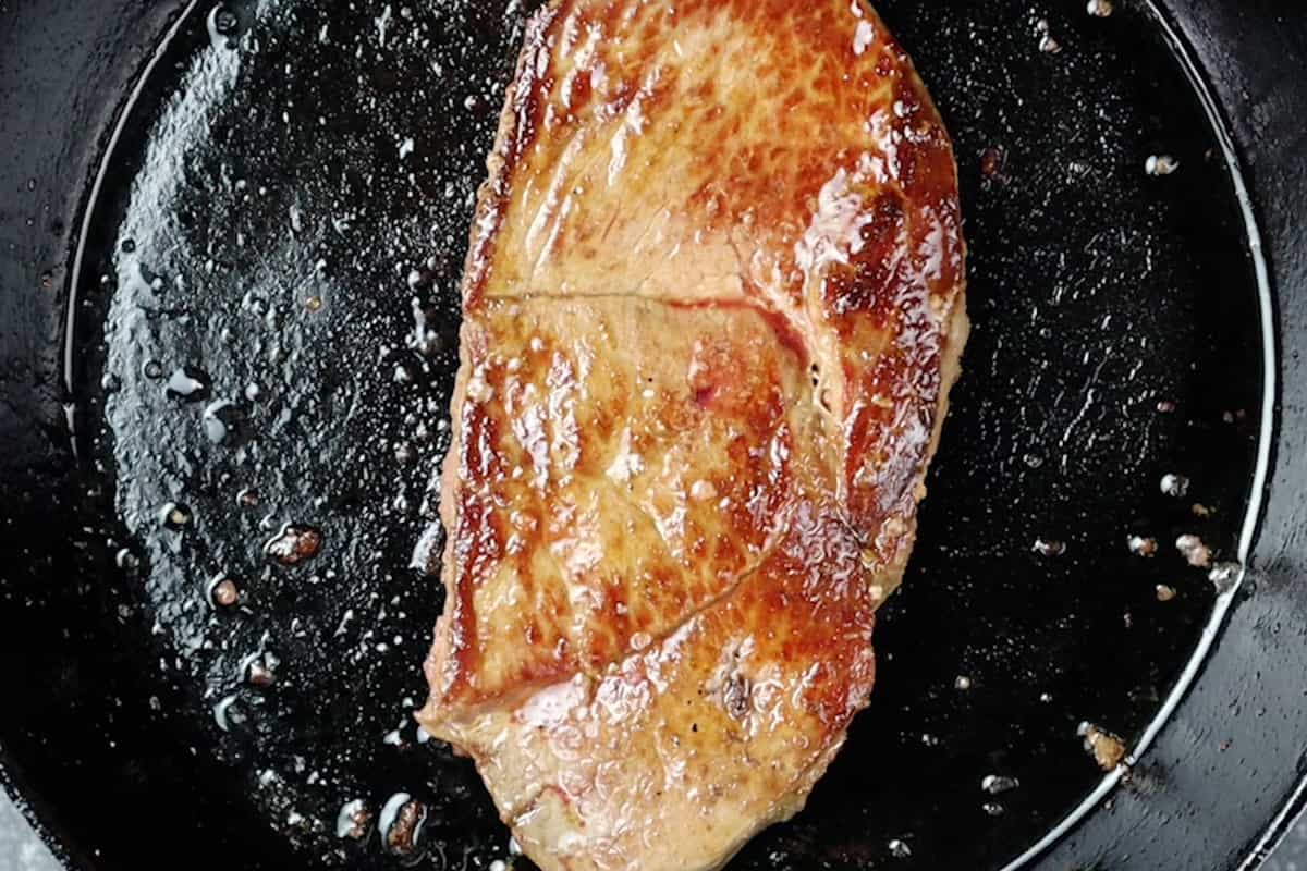 cooked steak in pan