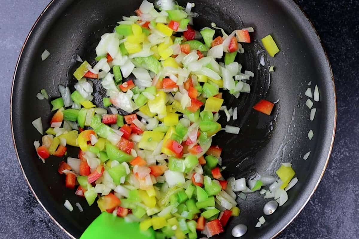 fresh onion and bell pepper in pan