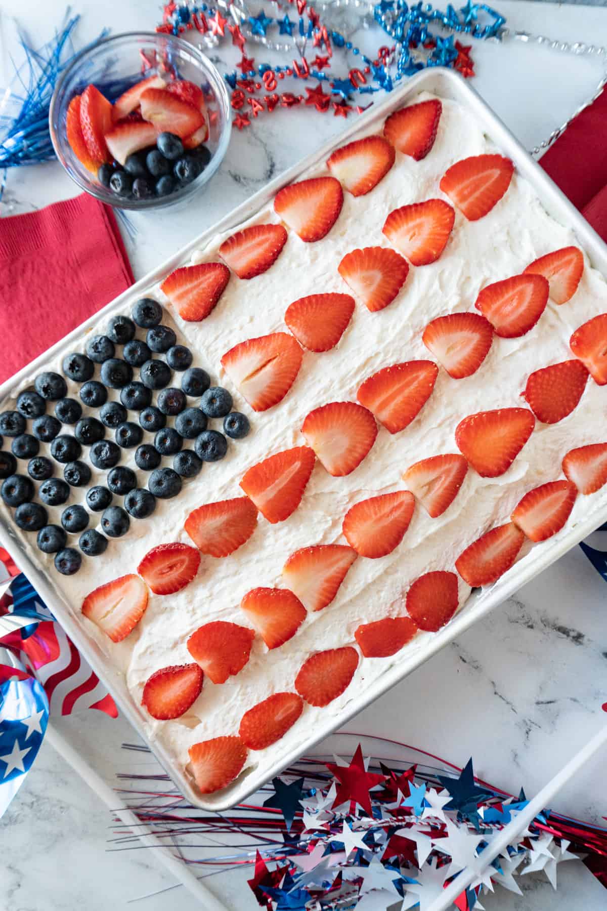 Flag cake surrounded by 4th of July decorations