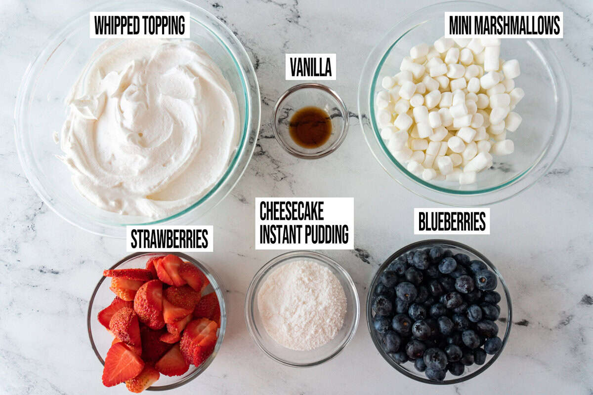 Ingredients for cheesecake salad are in individual bowls and labeled.