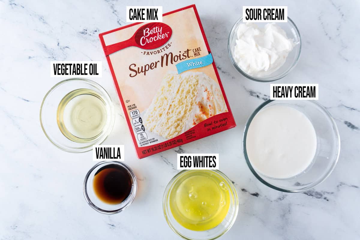 Ingredients for red, white, and blue cake in individual bowls and labeled.