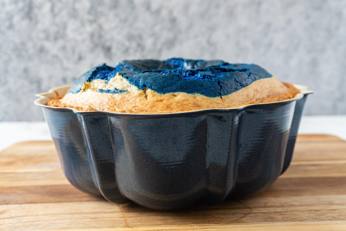 baked cake in bundt pan showing how it raised in baking past the edge of the pan