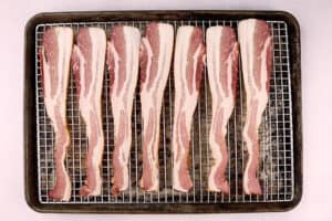raw bacon on wire rack