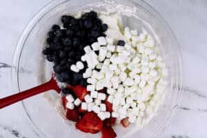 adding berries and marshmallows