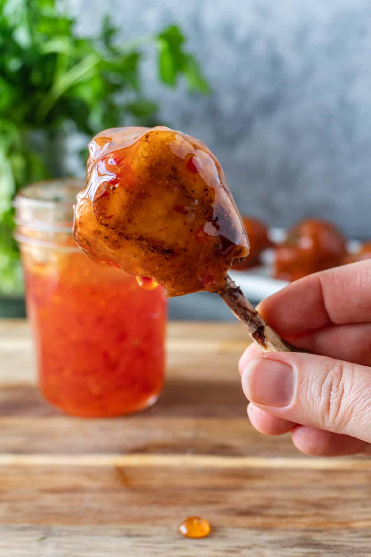 holding a Asian sauce dipped chicken lollipop