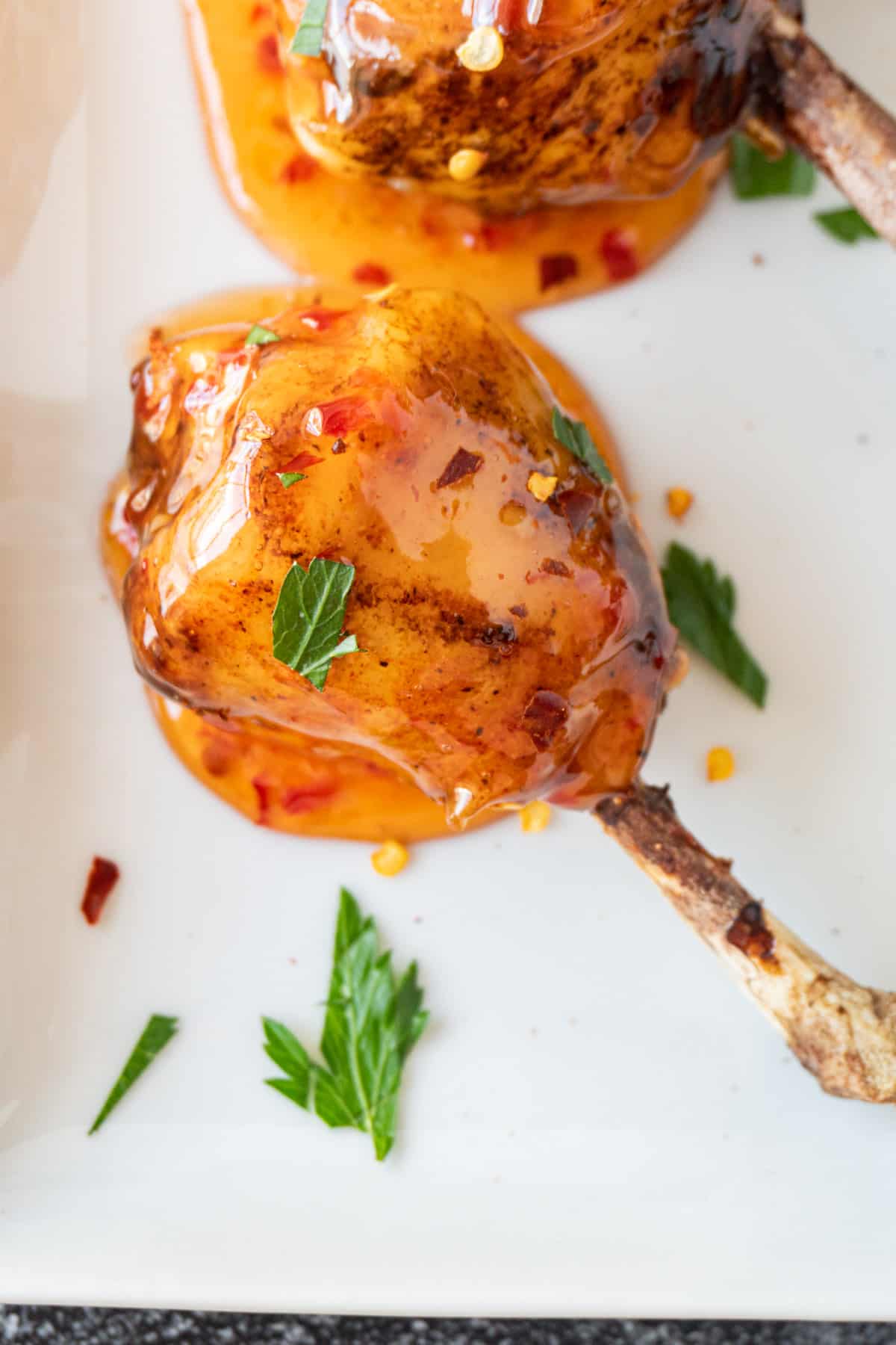 close up of chicken lollipop dipped in asian sauce