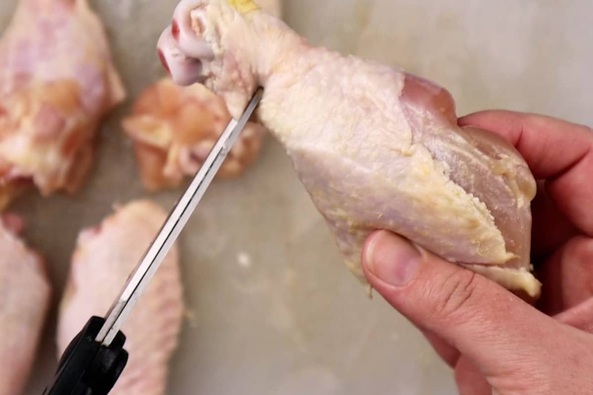 snipping the meat from the base of a drumstick
