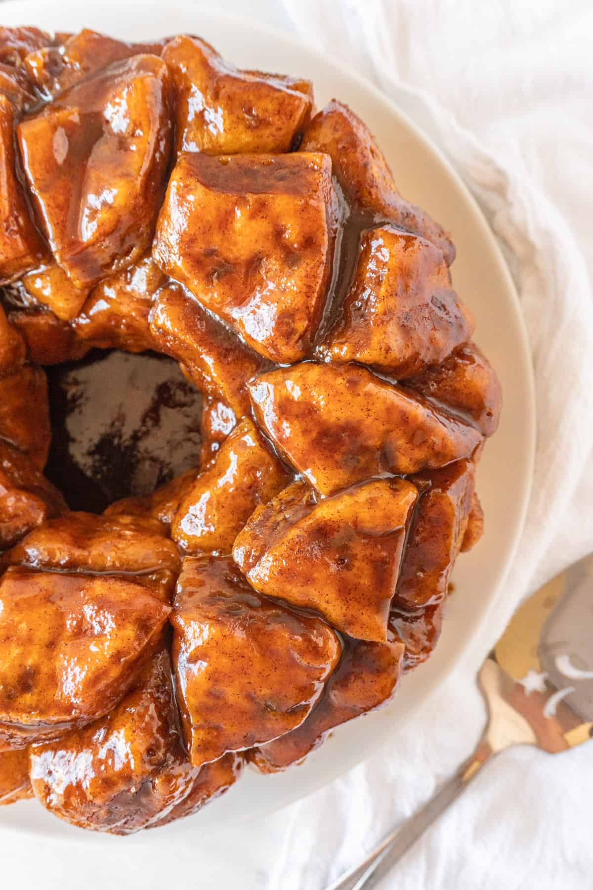 top of cinnamon pull apart bread on white plate.