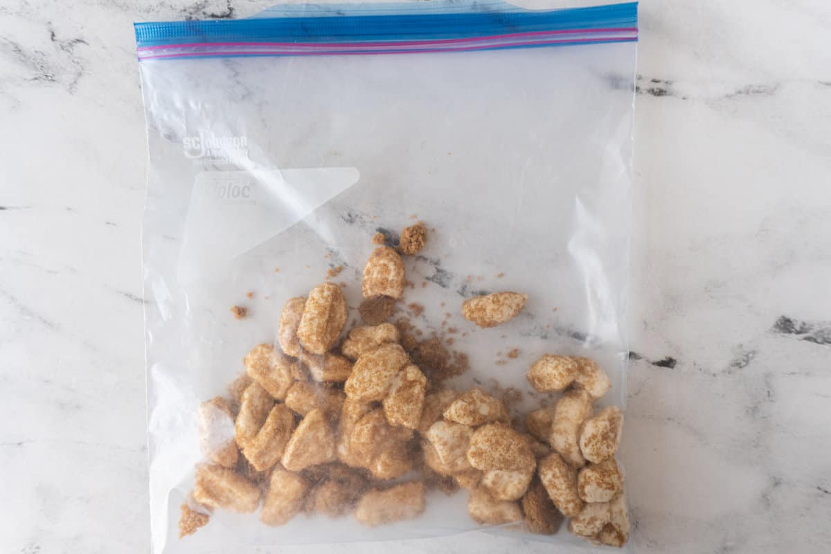 biscuit pieces in ziploc bag covered in brown sugar