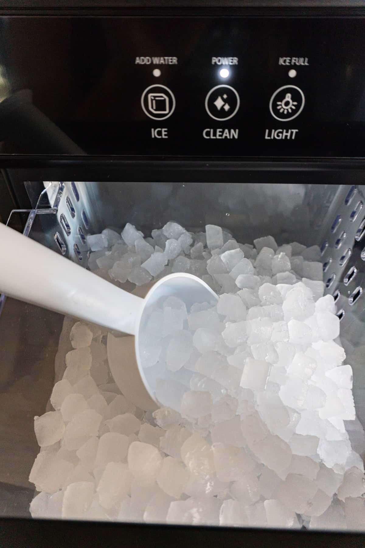 filled nugget ice maker drawer with scoop