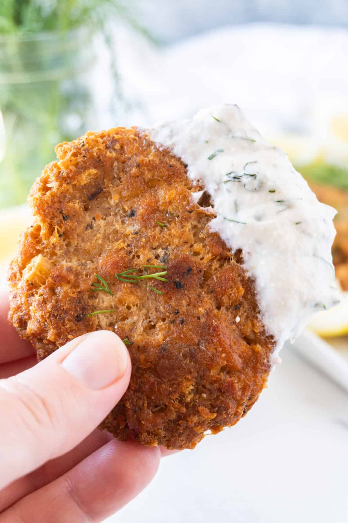 salmon patty with lemon dill sauce on it