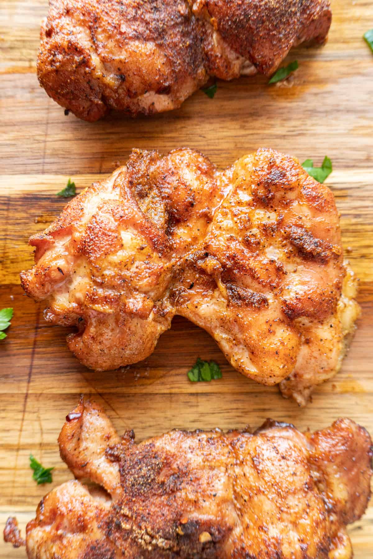 close up of smoked chicken thigh0 boneless skinless- on cutting board