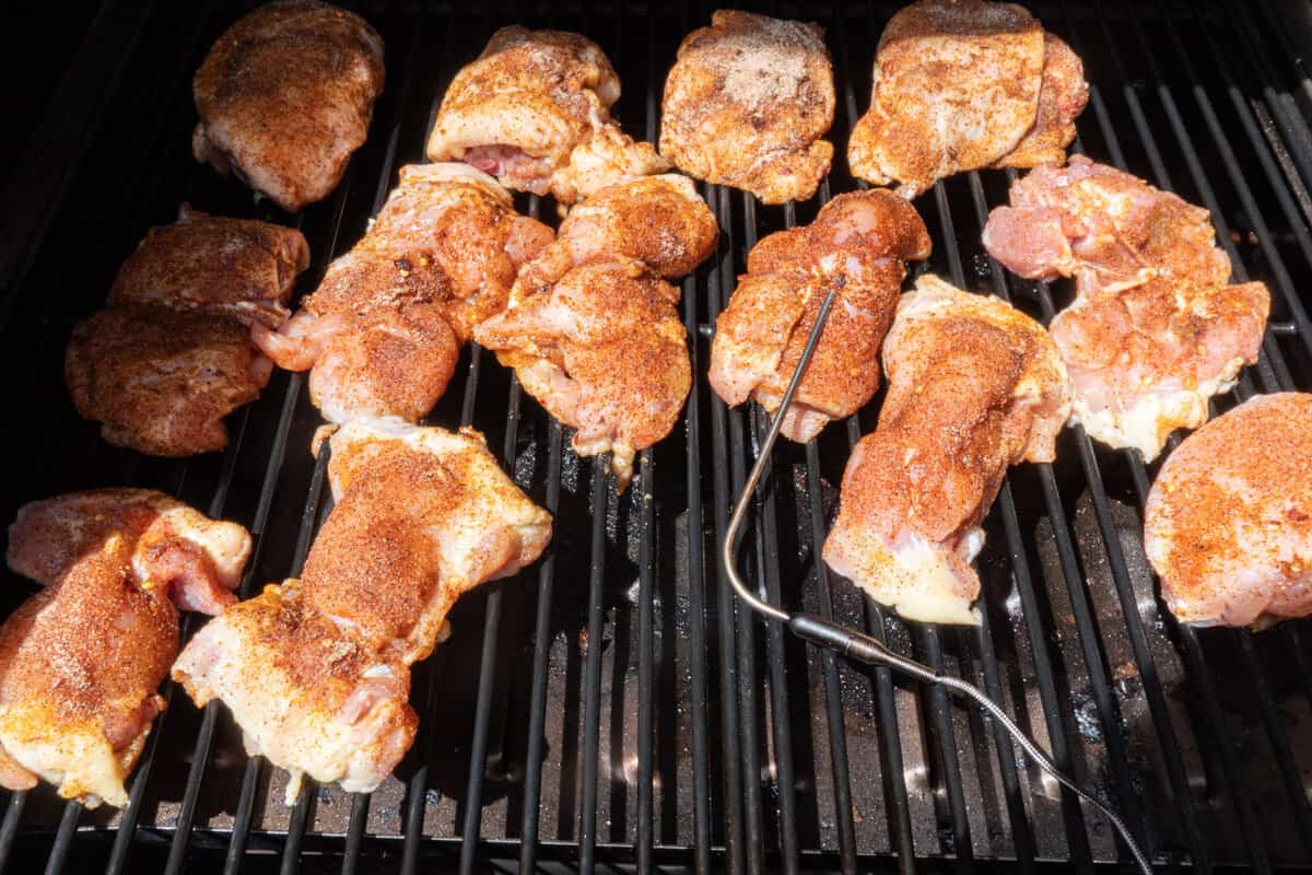 chicken thighss on smoker before being cooked