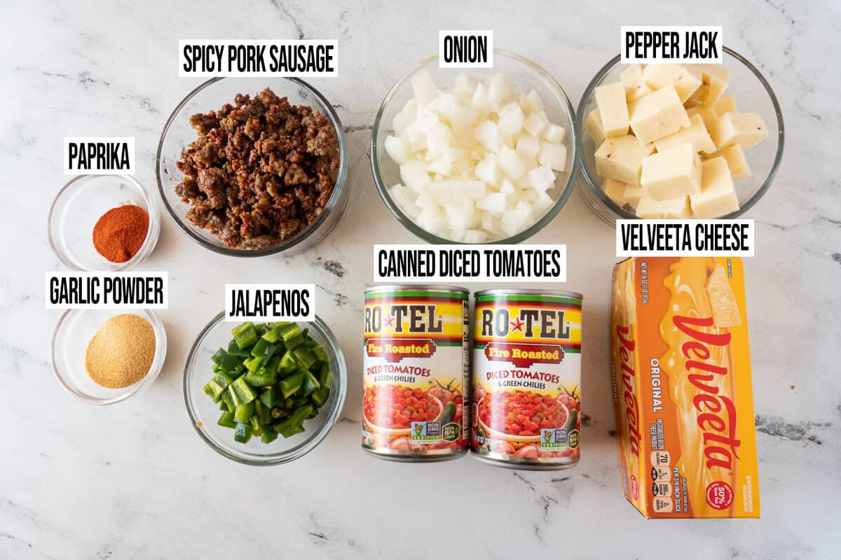 smoked queso ingredients in individual bowls and labeled.
