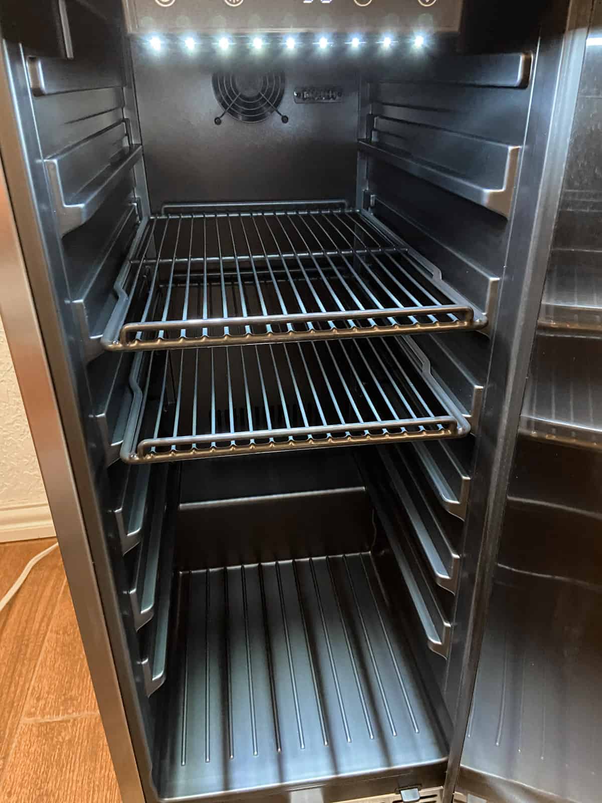 empty beverage fridge showing lights on