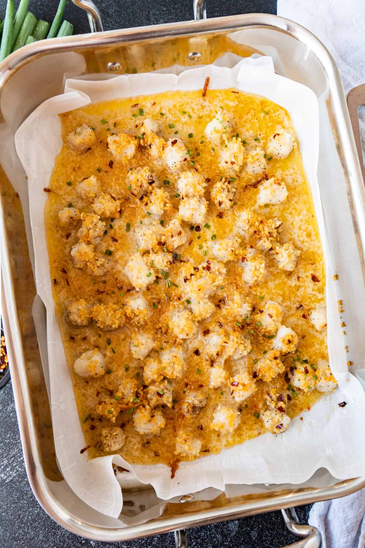 baked scallops in pan on parchment paper