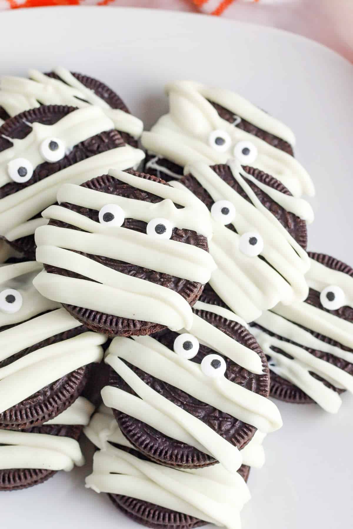 oreos decorated to look like mummys on plate