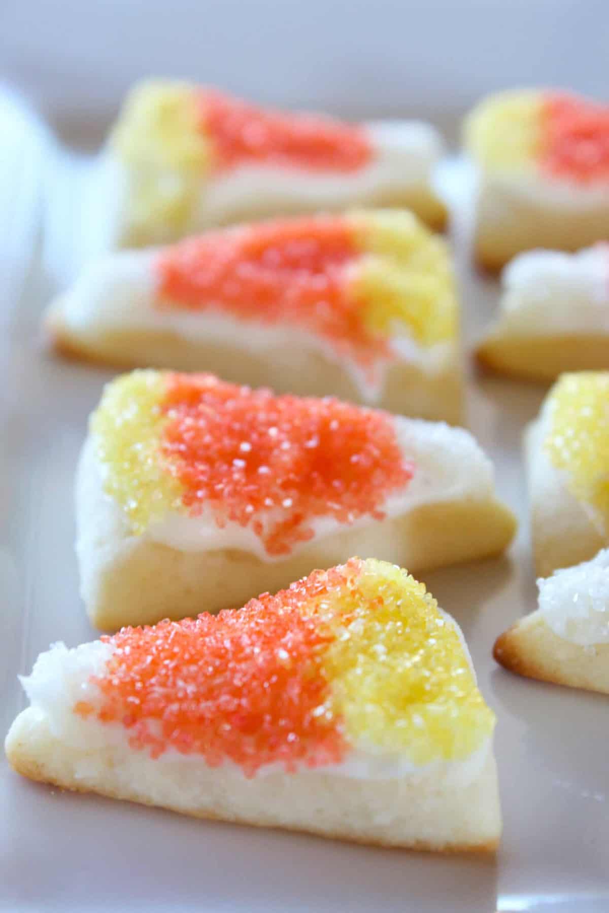 triangle sugar cookies decorated to look like candy corn