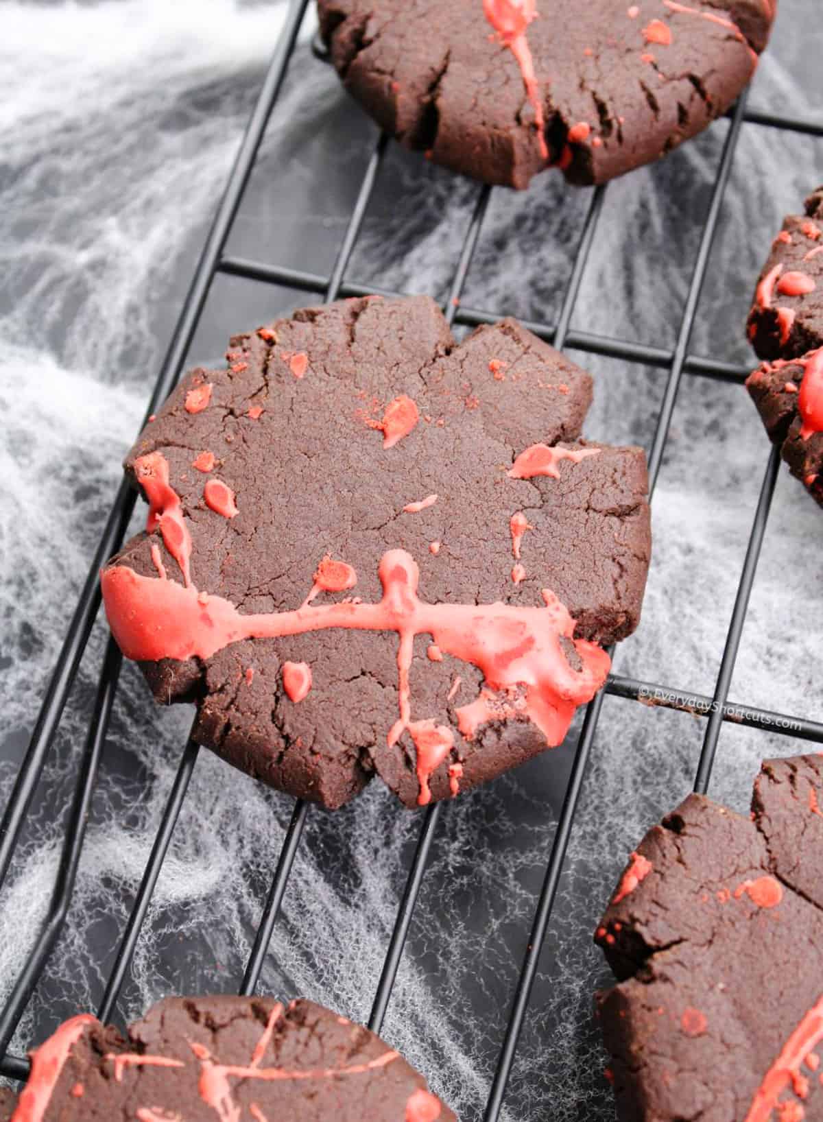 chocolate cookie with red splatters on baking sheet