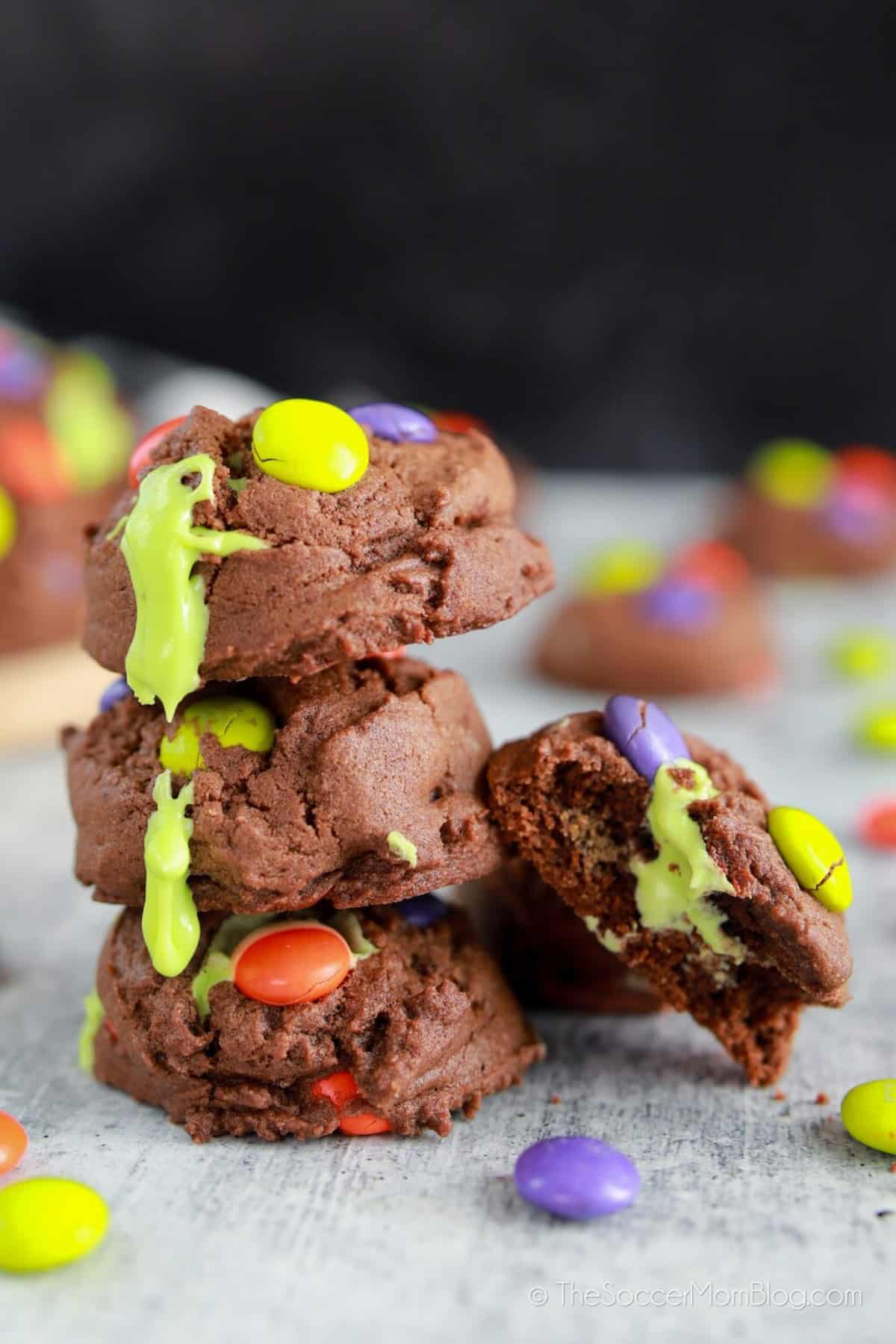chocolate cookies with M&Ms oozing green frosting