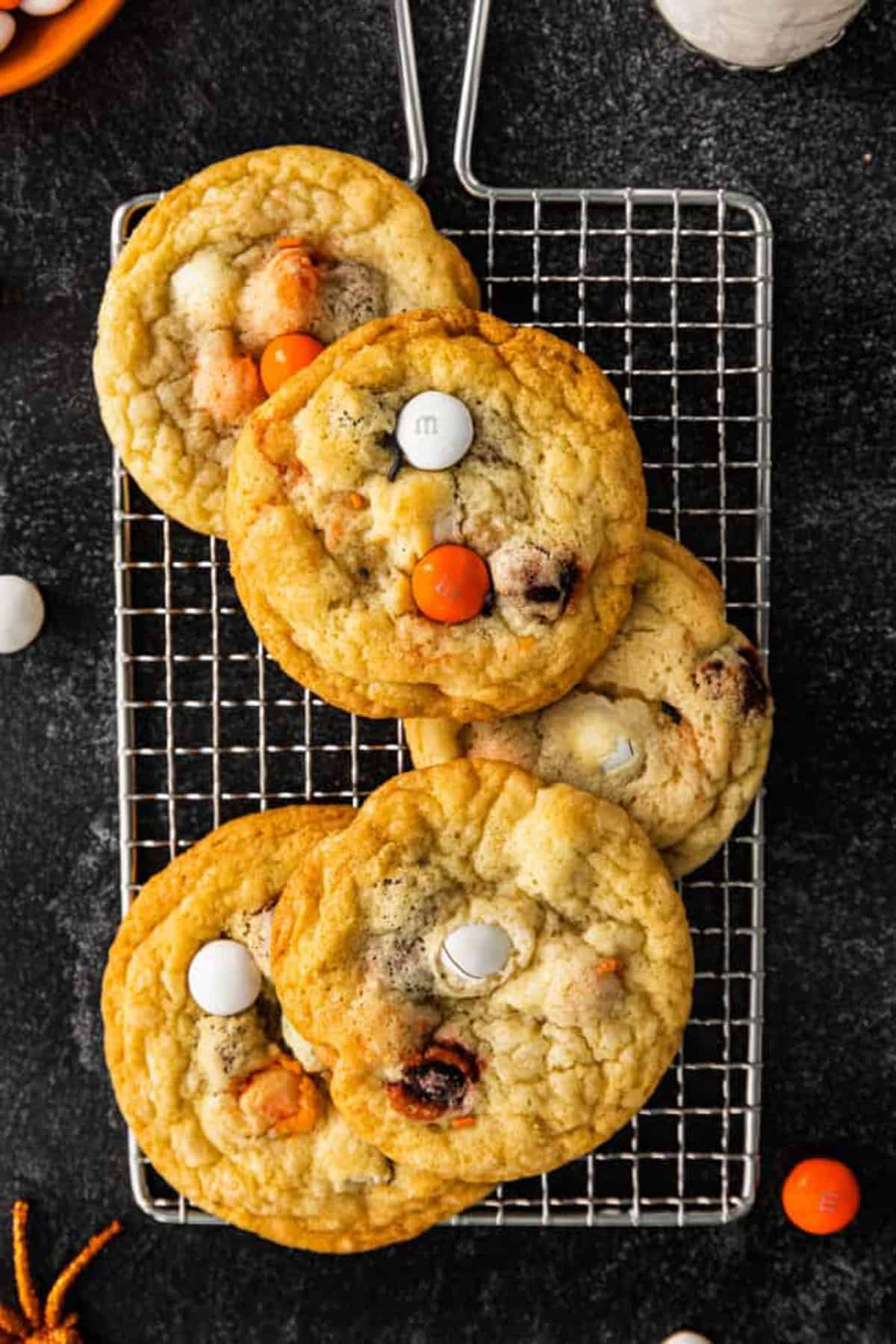 orange and white M&M cookies on baking sheet