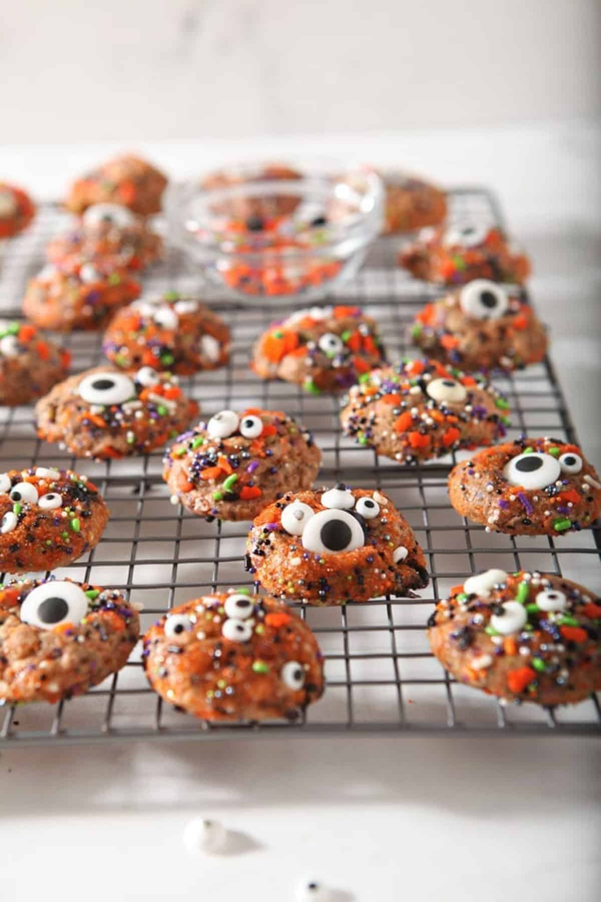 cookies with candy eyes all over, on baking sheet