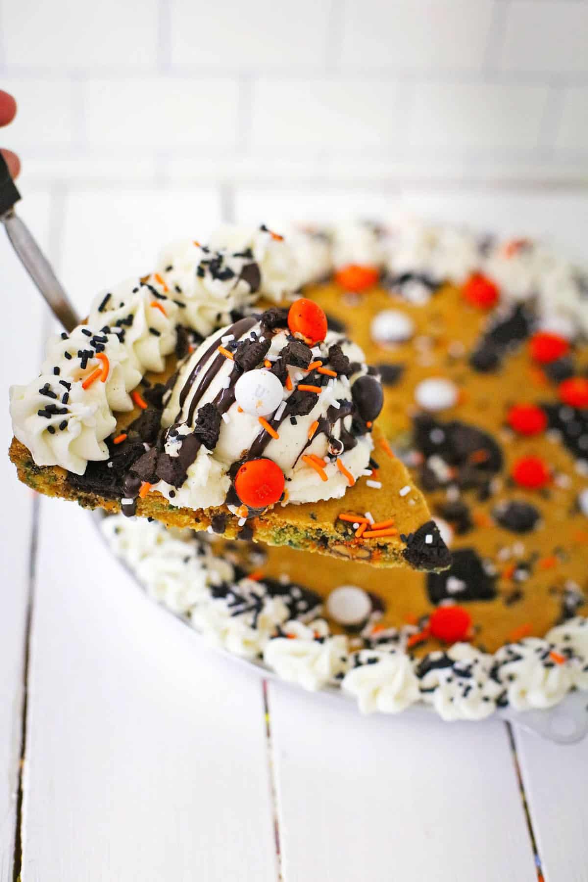 slicke of cookie pie with orange, white, and black decorations