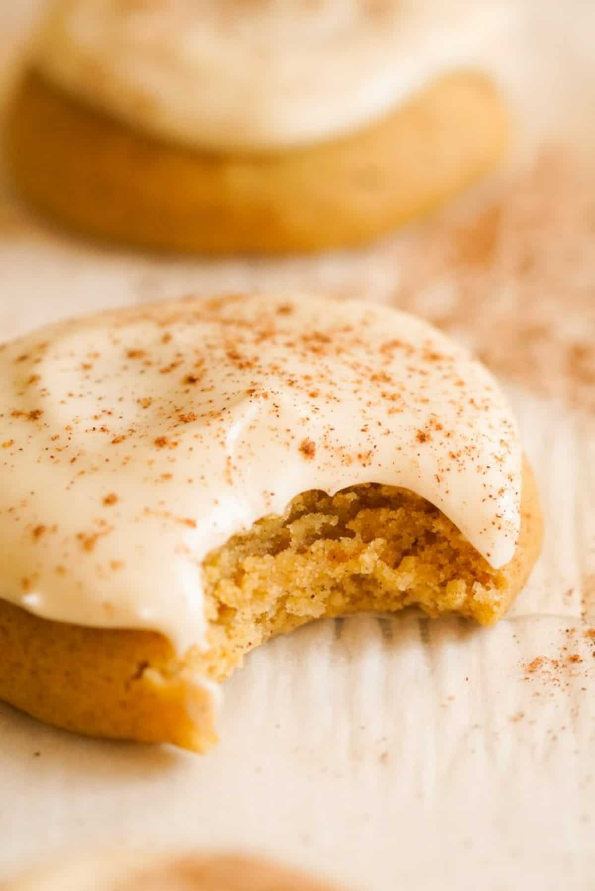 Pumpkin Sugar Cookies with cream cheese frosting with bite taken out