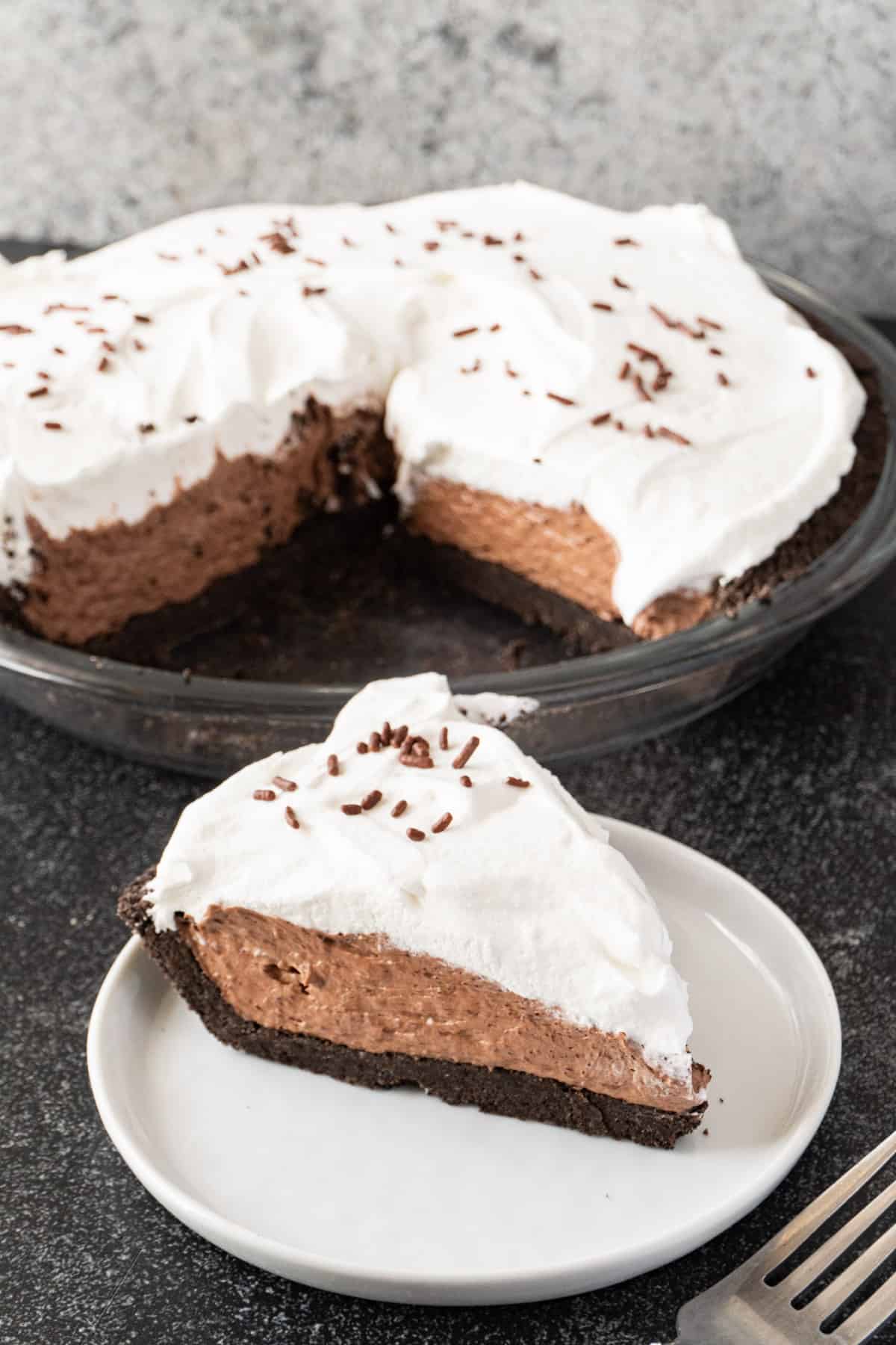 slice of chocolate pudding pie with whole pie in background