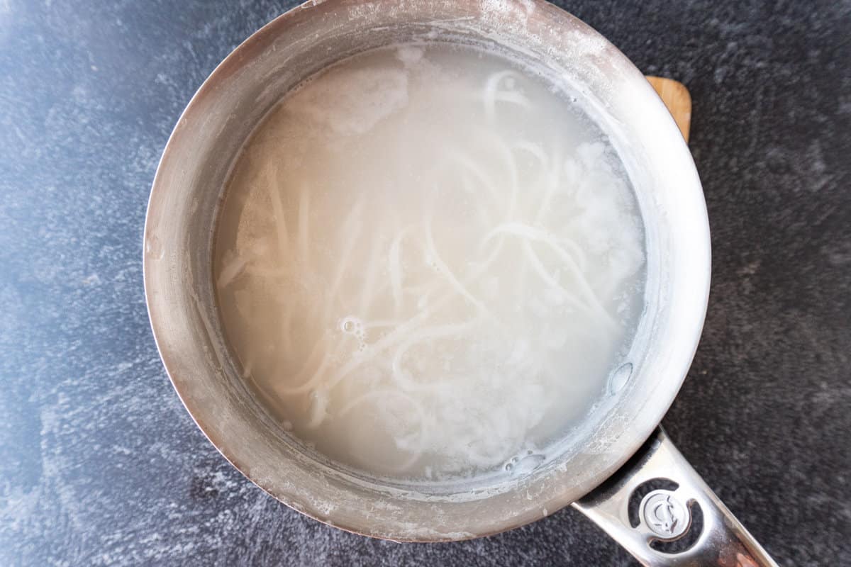rice noodles in water in pan