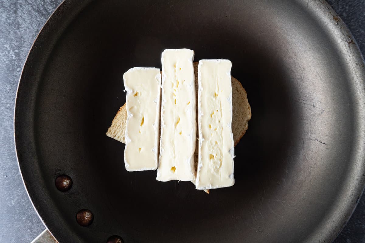 brie on top of bread in fry pan