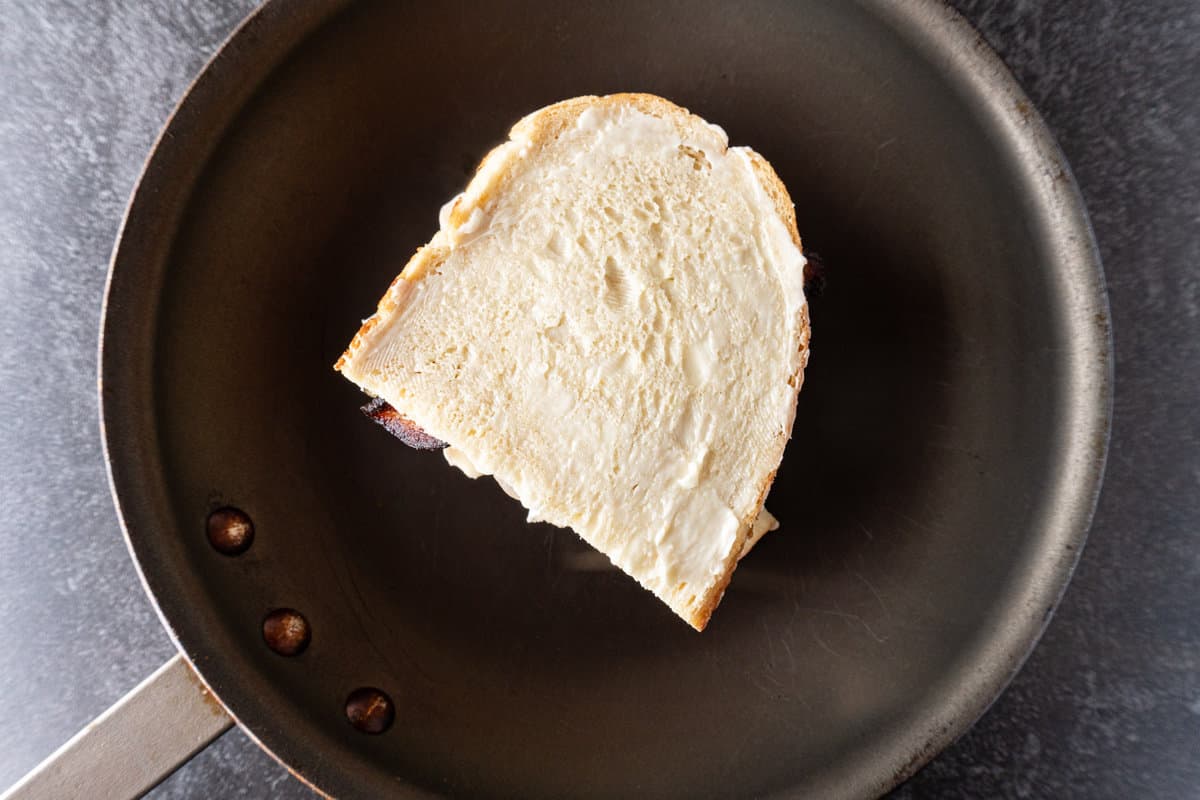 bread slice with butter side up added on top of onions