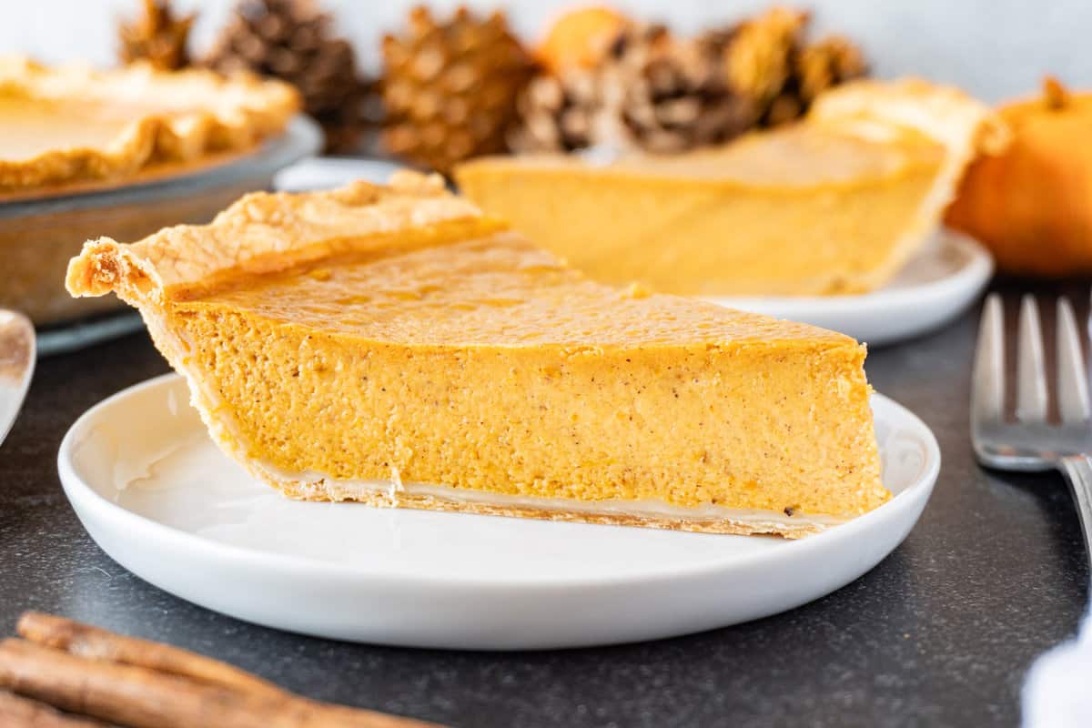 pumpkin pie with sweetened condensed milk slice on white plate