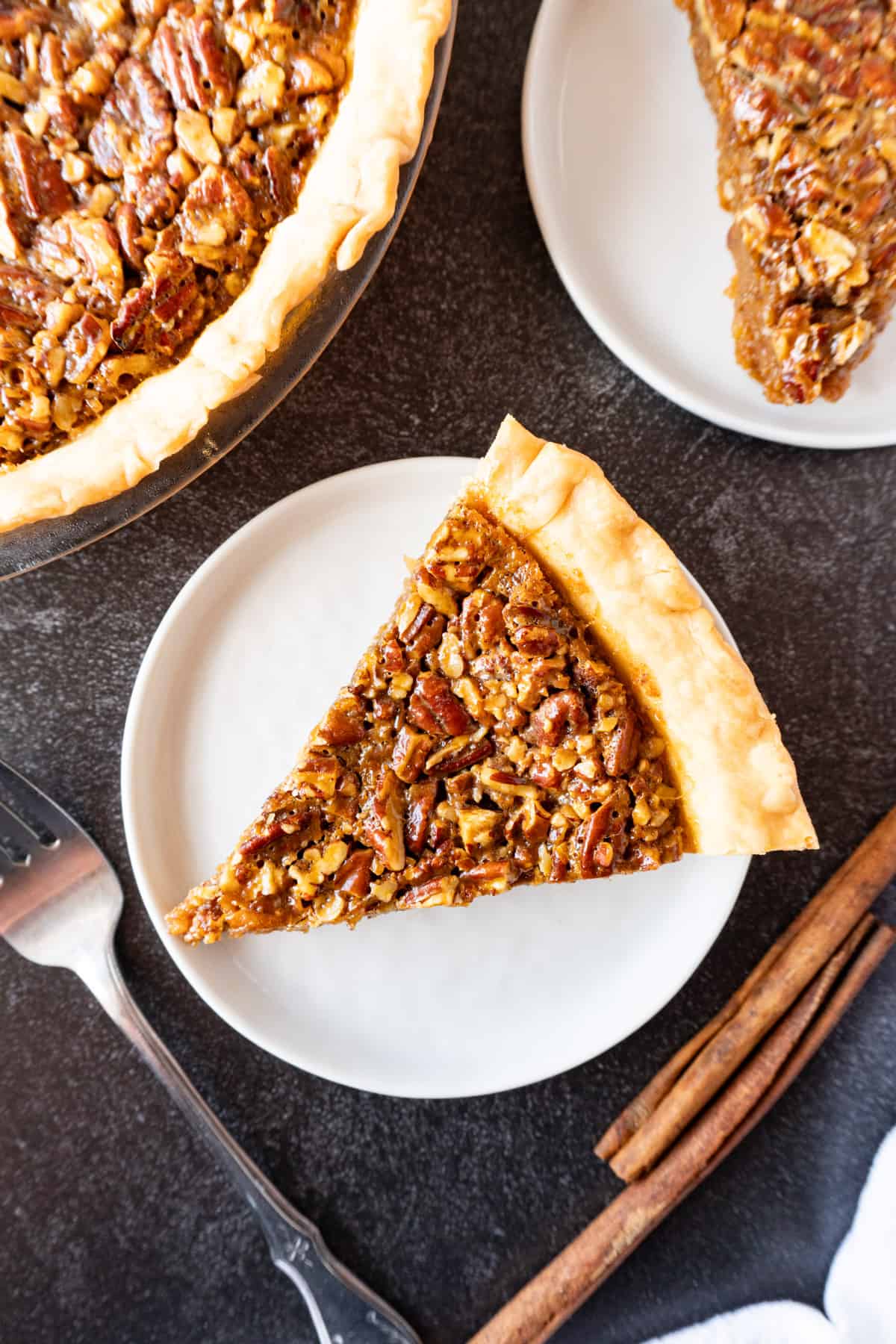 caramel pecan pie slice on plate flat lay